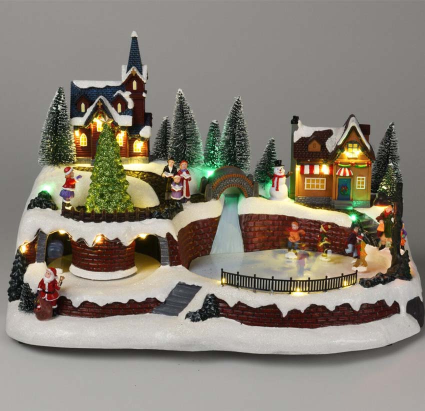 Maison de scène de village de Noël avec patineurs